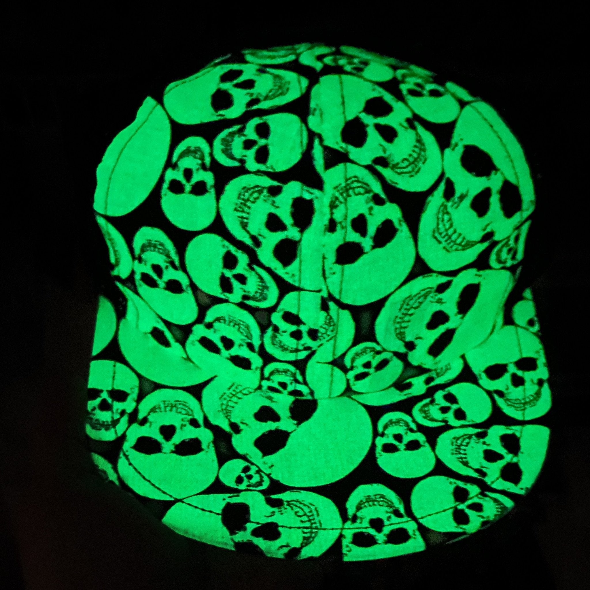 Image of the kid's trucker hat in the dark with glowing green skulls -Glow Skulls Trucker - George Hats