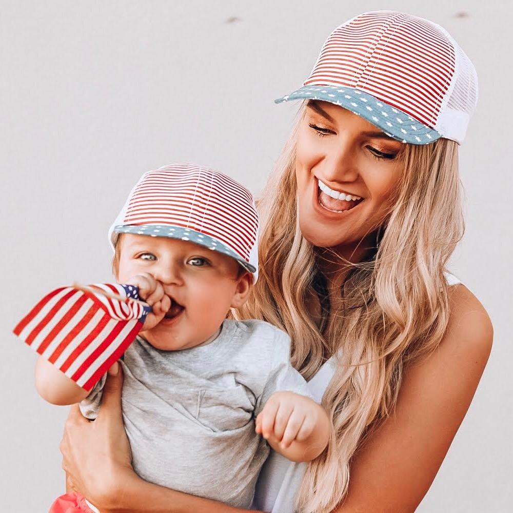 An image of a mother and child in matching Trucker Hats.