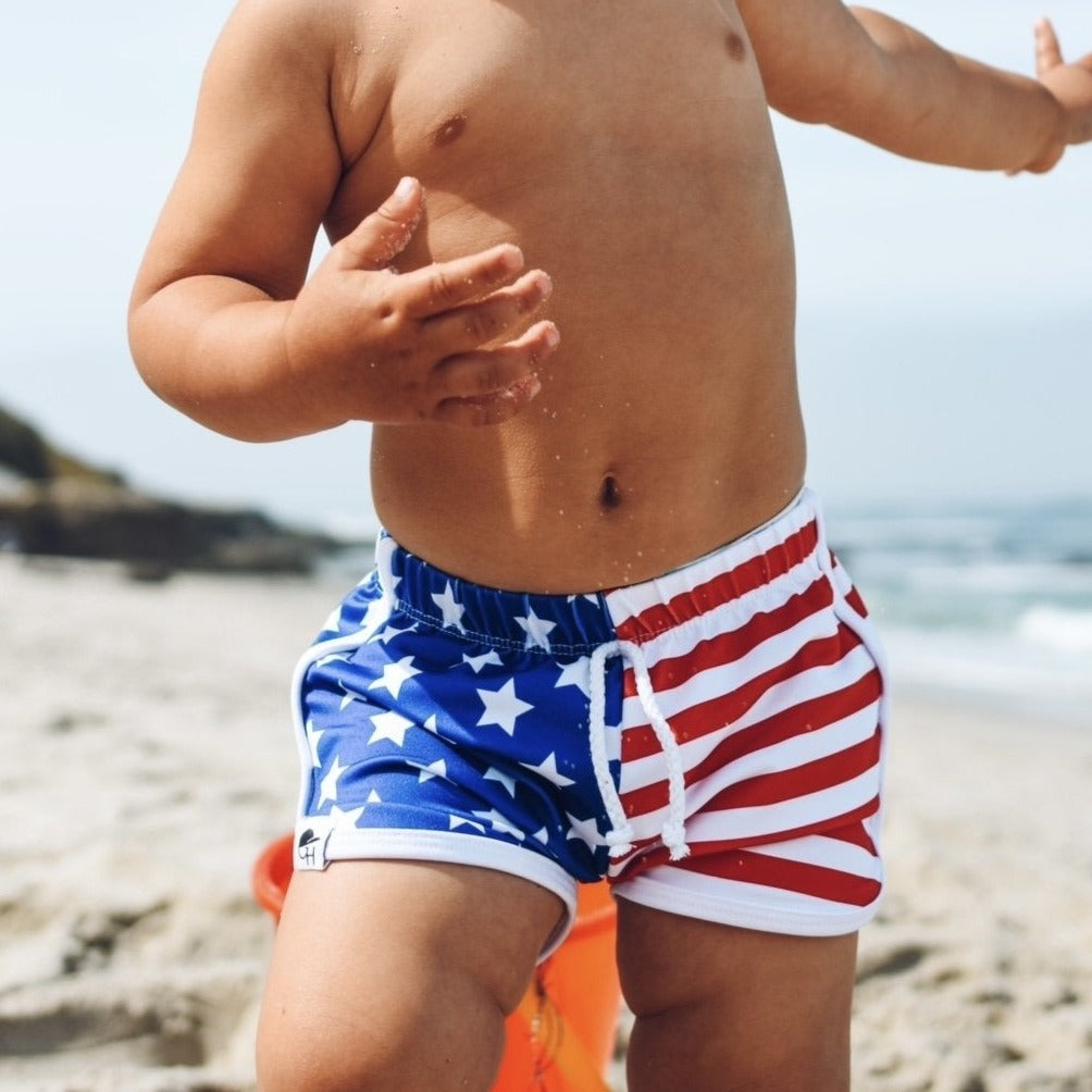 An image of a child in the Stars and Stripes Track Shorts.
