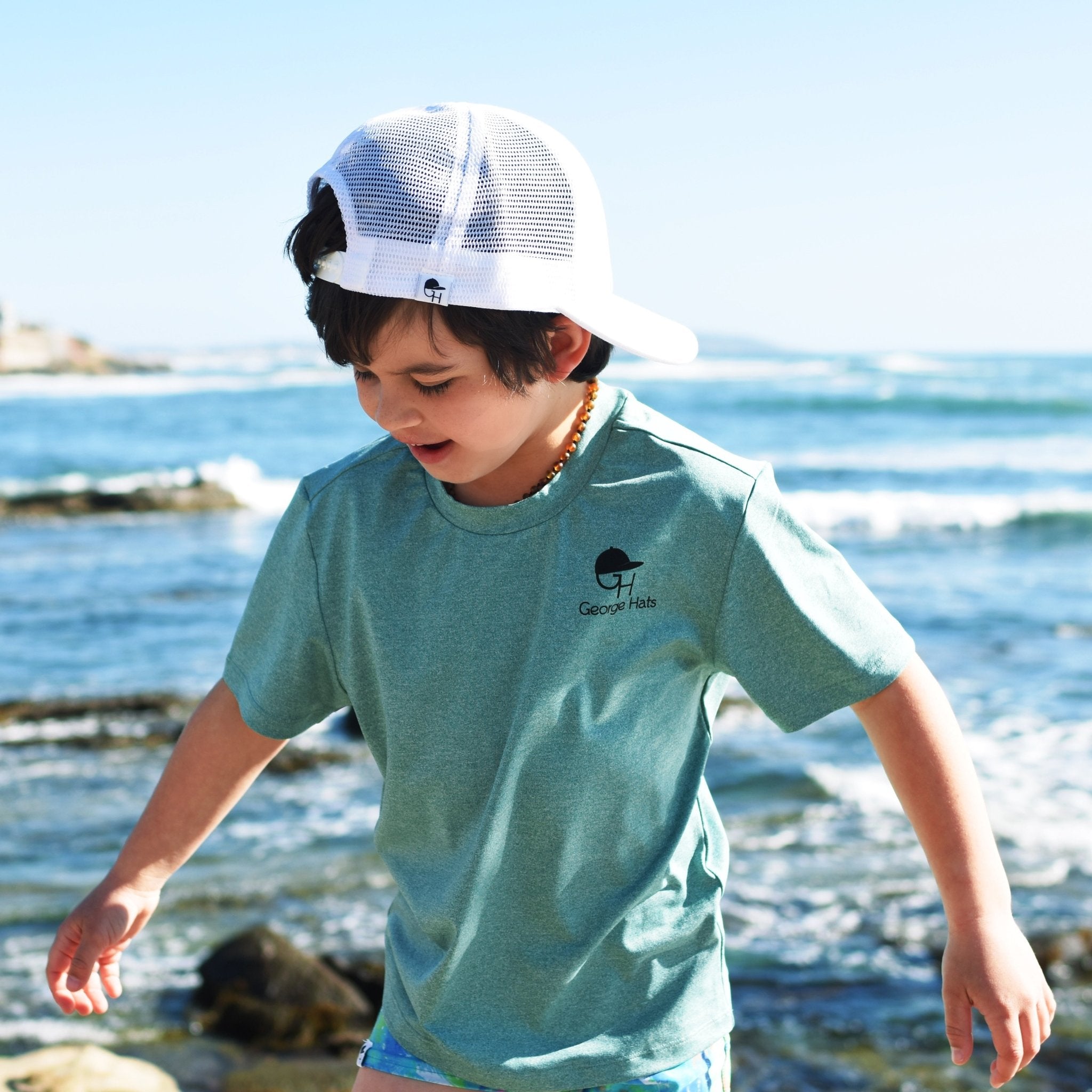 Image of child wearing a George Hats Sun Shirt.