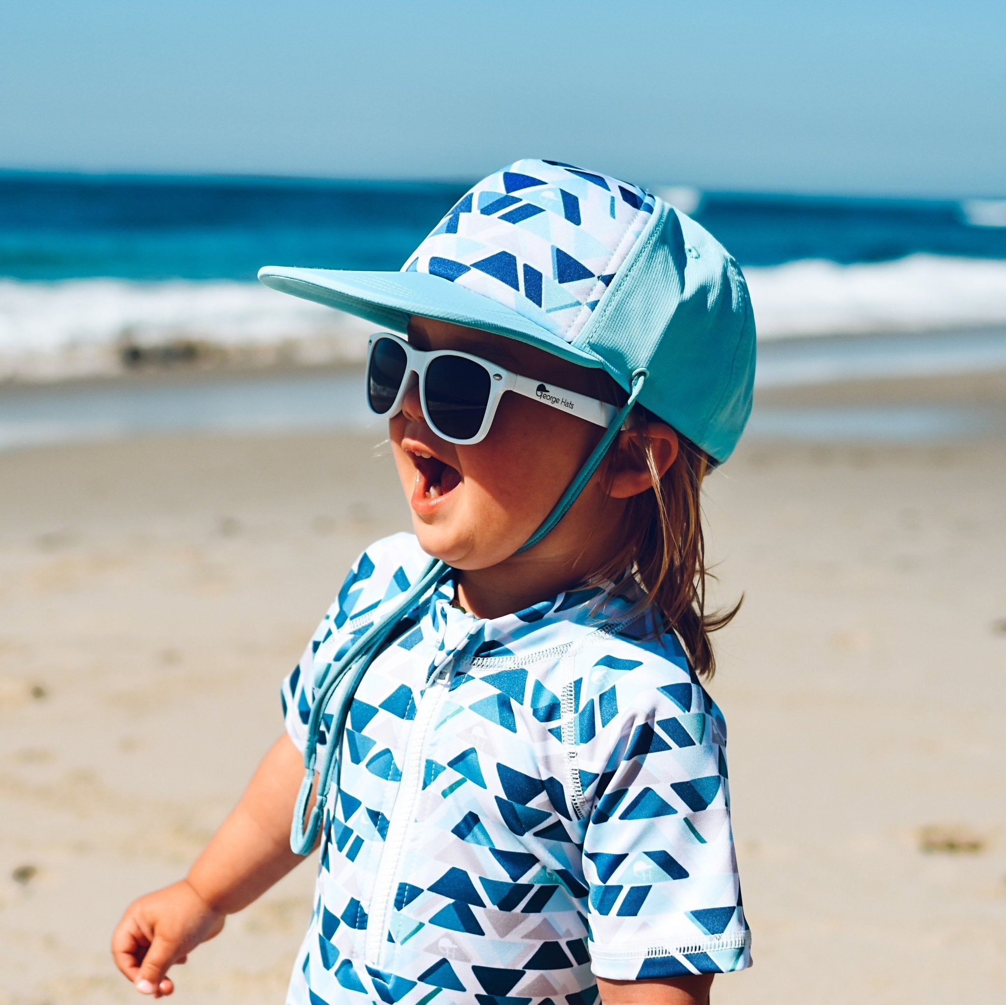 An image of a child wearing the watercolor surf hat.